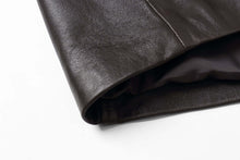 Load image into Gallery viewer, Close-up of genuine lambskin leather jacket sleeve, showcasing premium craftsmanship and soft texture, perfect for winter fashion.
