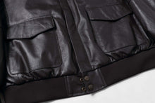 Load image into Gallery viewer, Close-up of REED Men&#39;s Premium Leather Aviator Bomber Jacket with front pockets and durable imported leather.
