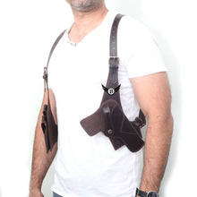Load image into Gallery viewer, Man wearing a cowhide leather vertical concealed holster right and left handers universal size, showcasing the shoulder fit.
