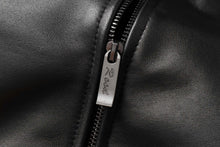 Load image into Gallery viewer, Close-up of black REED Men&#39;s New Zealand lambskin leather jacket zipper detail.
