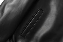 Load image into Gallery viewer, Close-up of black New Zealand lambskin leather jacket by REED with smooth, soft-touch finish, highlighting fine craftsmanship.
