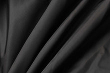 Load image into Gallery viewer, Smooth black fabric texture with elegant folds for premium clothing design background.
