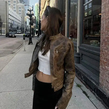 Charger l&#39;image dans la galerie, Woman wearing a vintage zip-up faux leather jacket in a city street, showcasing vegan leather with urban and timeless style.
