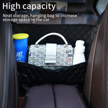 Load image into Gallery viewer, Luxury leather car handbag holder organizer between seats with a white handbag and bottles, showcasing high capacity storage solution.
