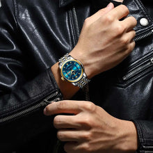 Cargar imagen en el visor de la galería, Man wearing luxury watch with blue dial and two-tone band, pairing with a black leather jacket for an elegant style statement.
