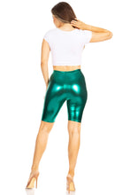 Charger l&#39;image dans la galerie, Woman wearing shiny metallic green bike shorts, showcasing the stretchy, unisex design made in USA.
