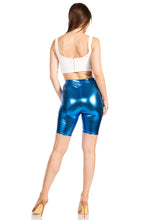 Charger l&#39;image dans la galerie, Shiny metallic blue unisex bike shorts, stretchy fabric, back view, made in USA, model wearing white top and heels, fashion apparel.
