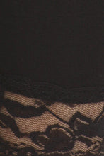 Load image into Gallery viewer, Close-up of lace trim detail on black stretch capri leggings, showing intricate floral pattern.
