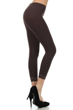 Load image into Gallery viewer, Side view of brown cotton blend lace trim stretch capri leggings with black high heels, designed for yoga and casual wear.
