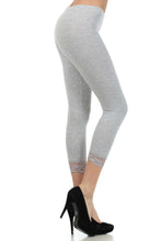 Load image into Gallery viewer, Model wearing grey cotton blend lace trim stretch capri leggings
