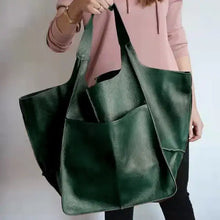 Load image into Gallery viewer, Green PU leather shoulder bag with a woman wearing a pink top, showcasing spacious and stylish design for daily use.
