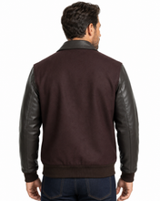 Load image into Gallery viewer, Man wearing REED leather varsity bomber jacket with wool body and leather sleeves, made in USA, classic and stylish design.
