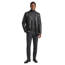 Load image into Gallery viewer, Man wearing a black leather jacket over a gray suit on a white background
