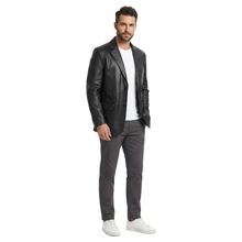 Load image into Gallery viewer, Man wearing a black leather jacket, white shirt, gray pants, and white sneakers on a white background
