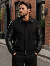 Load image into Gallery viewer, Men's Black leather varsity bomber jacket with wool body and leather sleeves, modeled by a man. Made in USA, classic and stylish design.
