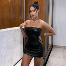 Load image into Gallery viewer, Woman wearing a chic faux leather dress, showcasing sleek design and sophisticated silhouette for a confident, stylish look.
