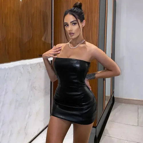 Woman wearing a chic faux leather dress, showcasing sleek design and sophisticated silhouette for a confident, stylish look.