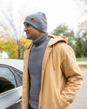 Load image into Gallery viewer, Man wearing NEW HAAKWEAR H-Stitch Cuffed Beanie - Designed and Made in USA (Patent Pending Design) - Koala Gray, standing outdoors.
