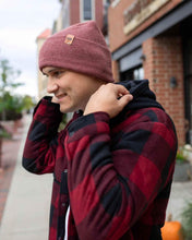 Charger l&#39;image dans la galerie, Man wearing NEW HAAKWEAR H-Stitch Cuffed Beanie - Designed and Made in USA (Patented Design) - Rusty Burgundy, outdoors.
