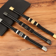 Load image into Gallery viewer, Three XQNI men&#39;s double layer woven leather bracelets with stainless steel clasps on a wooden surface.
