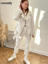 Load image into Gallery viewer, Woman wearing a white faux leather coat with fur lining, standing indoors. Casual chic winter fashion outfit.

