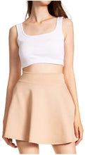 Load image into Gallery viewer, Woman wearing a basic versatile stretchy flared mini skater skirt, Made in USA, showcasing casual and fashionable style.
