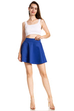 Load image into Gallery viewer, Woman wearing a blue flared skater skirt, white tank top, showcasing casual versatile style.
