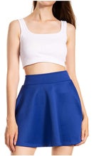 Load image into Gallery viewer, Woman wearing a blue flared mini skater skirt and white crop top for casual style.
