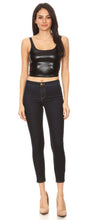 Charger l&#39;image dans la galerie, Woman wearing a stretchy sleeveless liquid metallic club crop tank top, paired with dark skinny jeans and beige heels, full body view.
