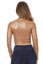 Load image into Gallery viewer, Back view of a matte liquid mock neck turtleneck long sleeve crop top in tan color, paired with dark jeans.
