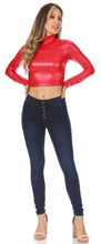Load image into Gallery viewer, Woman wearing a red matte liquid mock neck turtleneck long sleeve crop top paired with dark jeans, standing on white background.
