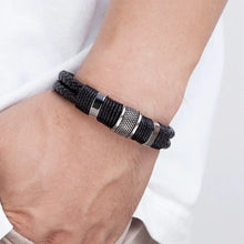Load image into Gallery viewer, Woven leather rope wrapping stainless steel men&#39;s bracelet on wrist, showcasing sleek design and high-quality materials.
