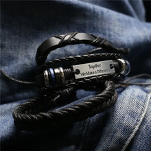 Load image into Gallery viewer, Men&#39;s leather bracelet with engraved &#39;Together We Make a Difference&#39; plaque on denim background, stylish and rugged accessory.
