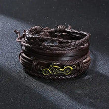 Load image into Gallery viewer, Braided leather wrap bracelet with intricate design on a textured surface, featuring a gold motorcycle charm.
