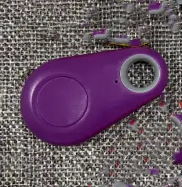Purple eThings Smart Mini GPS Tracker on textured surface, compact design for tracking valuables and pets with real-time location.