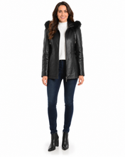 Load image into Gallery viewer, Woman wearing a black leather jacket with fur hood on a white background
