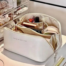 Load image into Gallery viewer, Leather cosmetic organizer with multiple compartments for makeup storage on a vanity.

