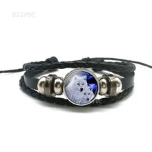 Load image into Gallery viewer, Handmade leather bracelet with wolf and moon design, featuring black braided leather and stainless steel details.
