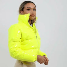 Load image into Gallery viewer, Model wearing a shiny PU leather winter jacket in vibrant yellow, showcasing its glossy finish and stylish design, perfect for cold weather.

