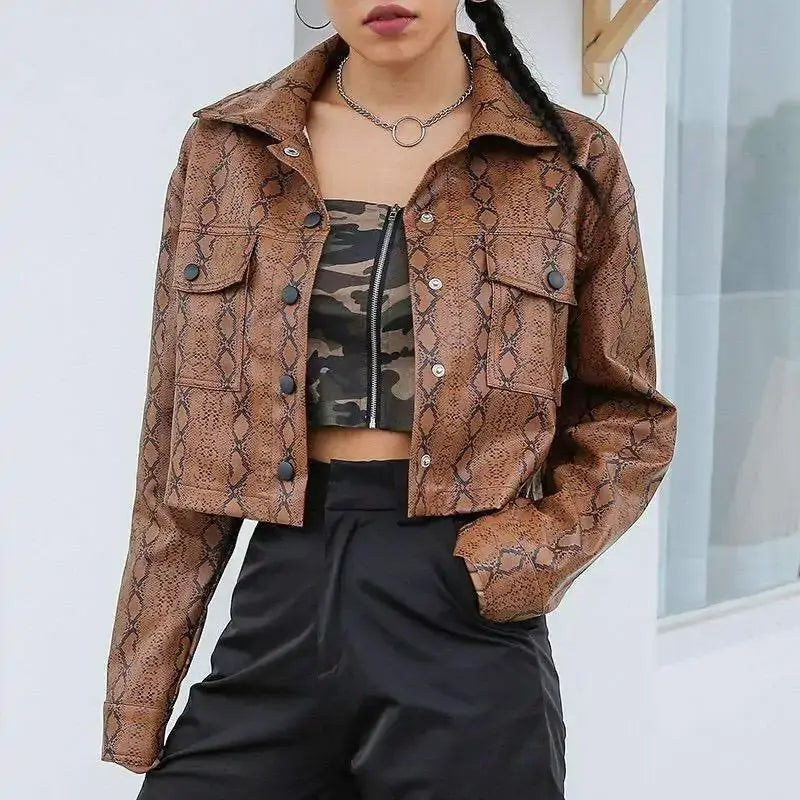Woman wearing a snake print vegan leather jacket, showcasing bold style, over a camouflage top and black pants.