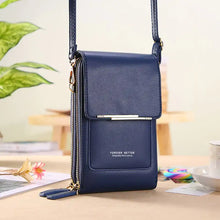 Load image into Gallery viewer, Stylish blue leather crossbody handbag on a table, showcasing elegant design and premium craftsmanship, perfect for versatile use.
