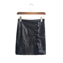 Load image into Gallery viewer, Black vegan leather high-slit skirt with belt on hanger, showcasing edgy and chic fashion style.
