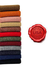 Load image into Gallery viewer, Stack of multicolored beanies next to a &quot;Made in USA&quot; seal, showcasing American craftsmanship.
