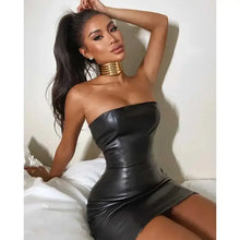 Load image into Gallery viewer, Woman wearing a chic faux leather dress, showcasing its sleek design and sophisticated silhouette, perfect for versatile style options.
