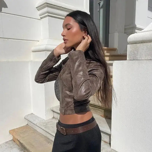 Woman wearing a vintage zip-up faux leather jacket outdoors, showcasing timeless style and sophistication.
