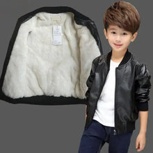 Cargar imagen en el visor de la galería, Boy wearing vegan leather and fur jacket with open view of white fur interior, showcasing style and warmth for winter fashion.
