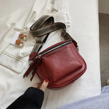 Load image into Gallery viewer, Red vegan leather vintage crossbody shoulder bag with striped strap on display for stylish and timeless fashion accessory.
