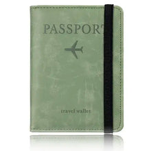 Load image into Gallery viewer, Green leather RFID-blocking passport holder travel wallet with black elastic band for security and style.
