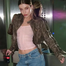 Charger l&#39;image dans la galerie, Model wearing vintage zip-up faux leather jacket with jeans, standing confidently with edgy style
