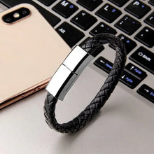Charger l'image dans la galerie, Sleek bracelet-type fast charge cord on desk next to phone and laptop for stylish, tangle-free rapid charging convenience.

